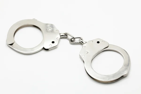 Закриті наручники на білому ізольованому фоні — стокове фото