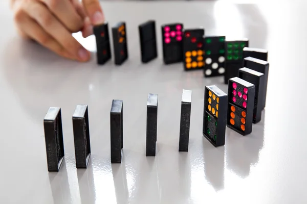 Az ember kezét játék domino fényes íróasztal — Stock Fotó