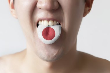 Japan flag painted in tongue of a man - indicating Japanese language and speaking clipart
