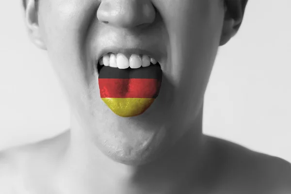 Germany flag painted in tongue of a man - indicating German language and speaking in Black and White — Stock Photo, Image