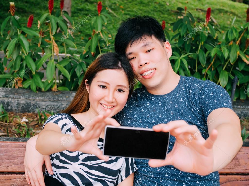 Outdoor watching asian couple