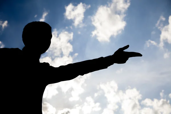 Silhueta de homem de negócios com Go gesto contra o céu por do sol — Fotografia de Stock