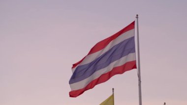 Thai flag fluttering with wind blow in clear sunset sky background - Kingdom of Thailand, Asian country in South East Asia