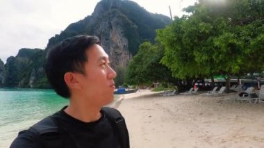 Plaj tatil beldesinde erkek turist vlog kaydı yapıyor