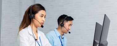 Ofiste çalışan bilgisayarları kullanan çağrı merkezi ajanları