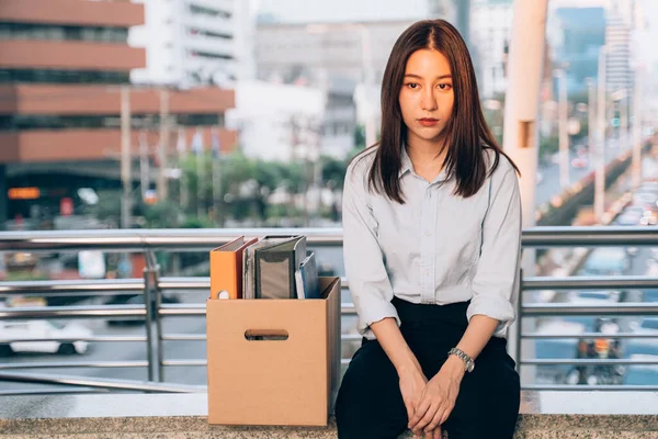 Depressed woman lost job sitting with box of items — Stock Photo, Image