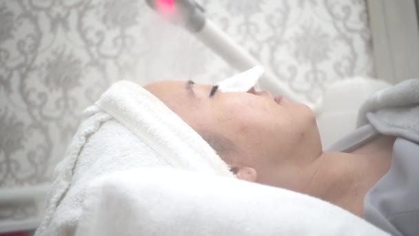 Beautiful young Asian woman getting cryotherapy therapy cosmetology in clinic — Stockvideo