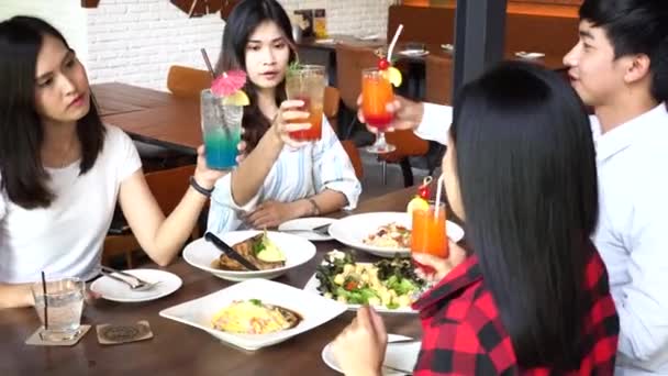 Asian good friends toasting, saying cheers and holding cocktail drinks at bar and restaurant — Stok video