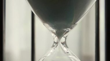 Time Lapse of hourglass clock sand dropping close up shot