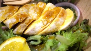 Dolly Shot of Chicken breast with fresh salad
