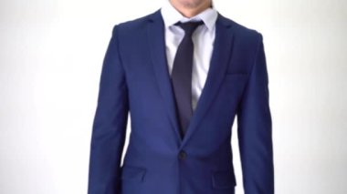 Confident business man walking into focus area, arms crossed on white background