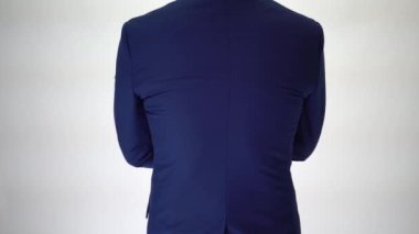Confident business man walking into focus area, arms crossed on white background
