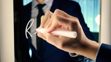 Smart business man writing the word RECRUITMENT on the mirror board