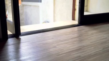 Close up of one persons feet walking inside the house without taking shoes off