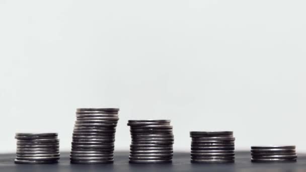 Coins diminishing on stack on white background — Stockvideo