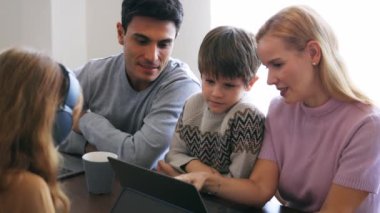 Young family using electronic device at home