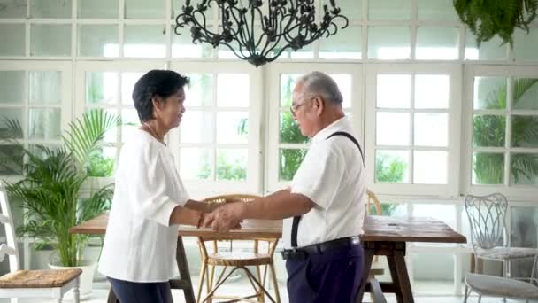 Velho casal asiático sênior dançando e sorrindo na sala de jantar — Vídeo de Stock