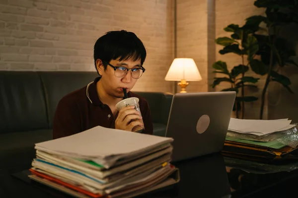 Man working late till night and drinking coffee — 스톡 사진