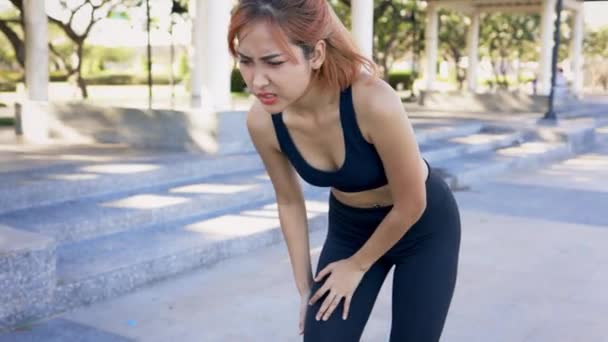 Woman suffering from knee pain while running — Stock Video