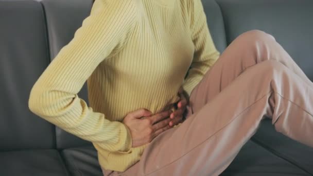 Young woman suffering from stomach ache — Stock Video