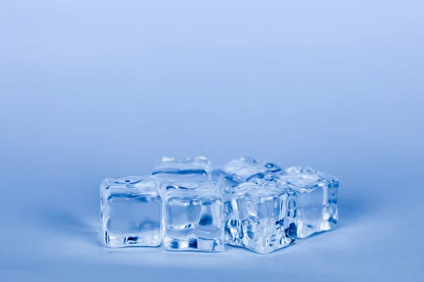 Ice cubes on grey background (blue cooling style) — Stock Photo, Image