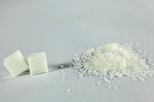 Sugar Cubes and White Granulated Sugar on Isolated White Background — Stock Photo, Image