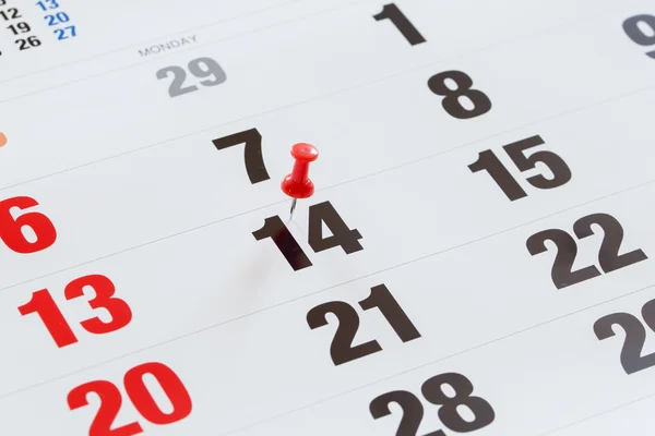 Pin pushed on a calendar concept for an important day. — Stock Photo, Image