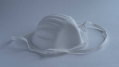 Beyaz arka planda güvenlik gözlüğü olan bir tıbbi yüz maskesi, izole edilmiş, konsept salgın koronavirüs