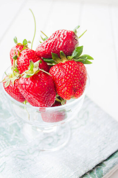 The red Strawberries in the glass. The bowl of strawberries. Summer fruits.