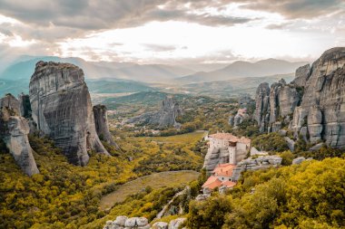 Amazing panoramic sunset view of the Valley of Meteora, Thessaly, Greece with monasteries and unique rock formations clipart