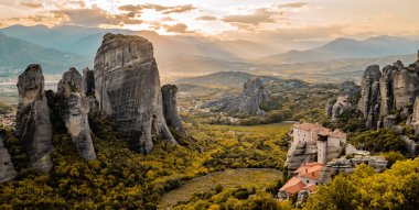 Yunanistan 'ın Meteora, Teselya Vadisi' nin muhteşem yatay günbatımı manzarası. Manastırları ve eşsiz kaya oluşumları var.