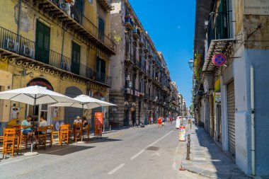 Palermo, İtalya - 29 Temmuz 2020 - Palermo, Sicilya 'daki kafede teraslı geleneksel İtalyan evleriyle yürüyen turistlerin görüntüsü