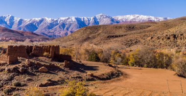 Fas 'taki Yüksek Atlas Dağları' ndaki harabelerin ve manzaraların panoramik manzarası. Arka planda karlı zirveler var.