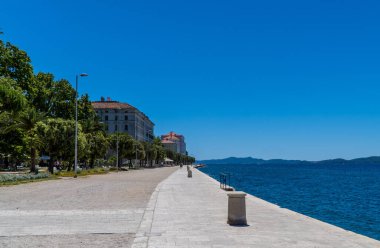 Zadar, Croatia - July 11, 2020 - promenade on the sea with the buildings of Zadar University in the background