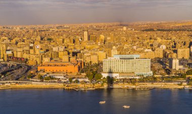 Cairo, Egypt - March 25, 2021 - beautiful aerial panoramic view of the Ritz Carlton Nile Hotel with the Nile River and Cairo Skyline in the background at sunset