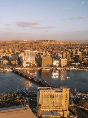 Kahire, Mısır - 25 Mart 2021 - günbatımında Ritz Carlton Nile Hotel, Novotel ve Kahire Skyline dikey hava görüntüsü