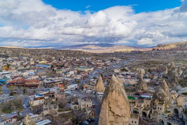 Goreme, Turkey - March 20, 2020 - beautiful horizontal panoramic view of the center of the town of Goreme in Cappadocia, Turkey with fairy chimneys, houses, and unique rock formations