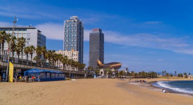 Barcelona, Spain - April 15, 2021 - panoramic view of Barceloneta Beach (Platja Barceloneta) with skyscrapers and Mapfre headquarters in the background clipart