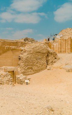 Saqqara, Mısır - 1 Nisan 2021 - Mısır 'daki en eski piramit olan Djoser Piramidi' ndeki bir mezardan turistlerin ve işçilerin güneşli dikey görüntüsü