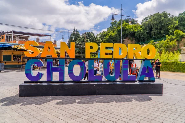 墨西哥乔卢拉 2021年8月29日 乔卢拉城中的乔卢拉的字母标志 背景是乔卢拉金字塔上的Virgen Los Remedios教堂 — 图库照片