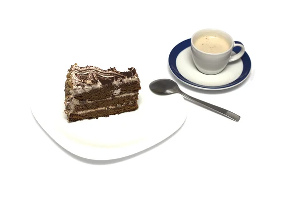 Chocolate cake and mug of a cappuccino with a tea spoon — Stock Photo, Image