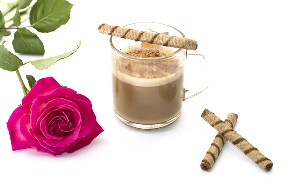 Mug of a cappuccino and a rose on a white background