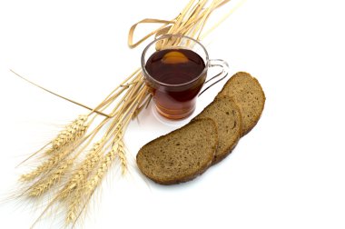 bread and ears of wheat, glass of tea