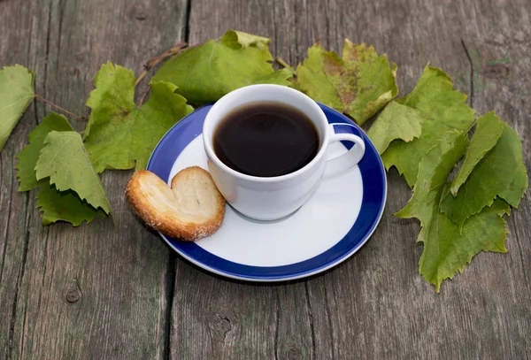 fincan kahve bir daire, bir kurabiye, üzerinde oyun ile süslüdür