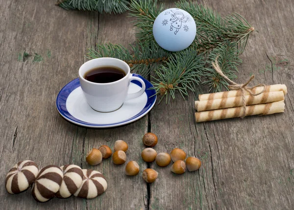 Fir-tree branch, coffee, sweets, hazelnuts still life — Stock Photo, Image