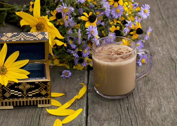 bouquet of flowers, cappuccino, casket and petals