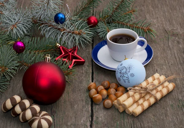 Fir-tree branch with Christmas tree decorations, coffee, differe — Stock Photo, Image