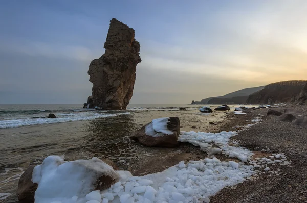 High, a lone rock on the coast. — Stock Photo, Image