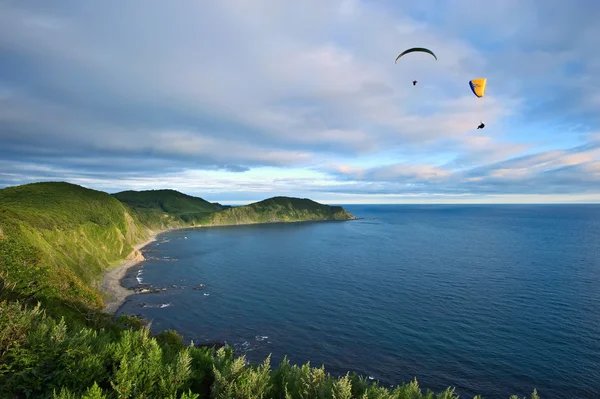 Two paraglider flying over the coast. — Stock Photo, Image