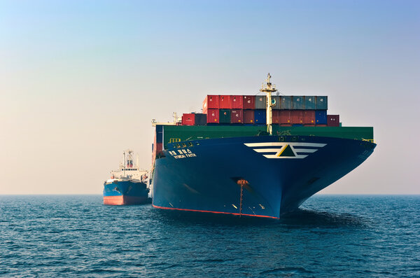 Nakhodka, Russia- 19.04.2014: Bunkering tanker Ostrov Russkiy container ship Hyundai company. Nakhodka Bay. East (Japan) Sea. 19.04.2014